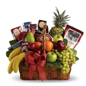 A basket of fruit and cheese is shown.