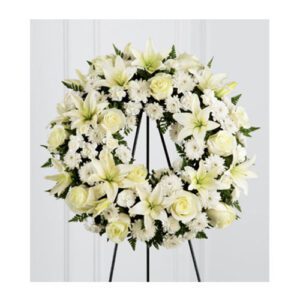 A white wreath with yellow flowers on it.