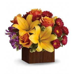 A bouquet of flowers in a wooden box.
