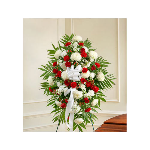 A funeral standing spray with red and white flowers.