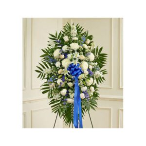 A blue and white standing wreath with flowers.
