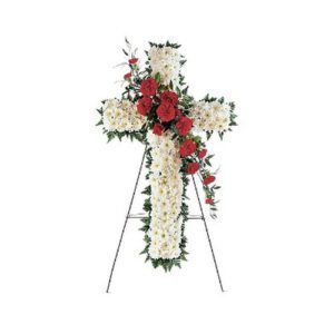 A cross with white flowers and red roses.