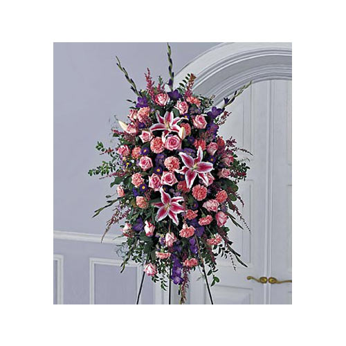 A large floral arrangement with pink flowers and purple leaves.