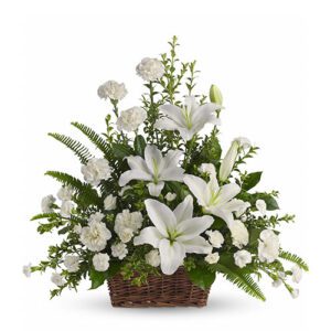 A basket of white flowers with greenery.