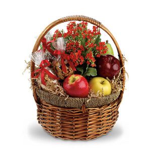 A basket of fruit with flowers and plants.