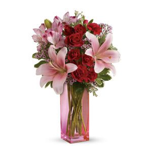 A bouquet of flowers in a pink vase.