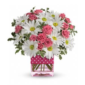 A bouquet of flowers in a polka dot vase.