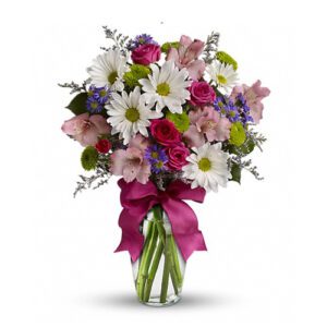 A vase filled with flowers and a pink bow.