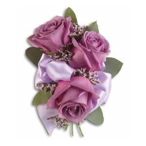 A purple rose corsage with satin ribbon.