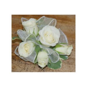 A bouquet of white roses on top of a wooden table.