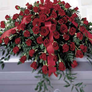 A bouquet of roses is shown on top of a table.