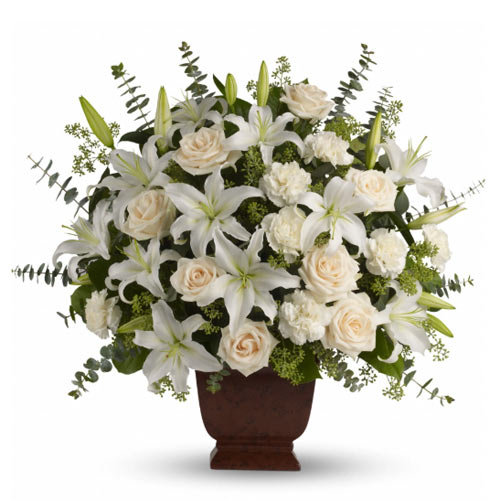 A bouquet of white flowers in a brown vase.
