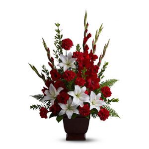 A bouquet of red and white flowers in a vase.