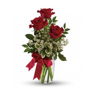 A bouquet of roses in a vase with red ribbon.