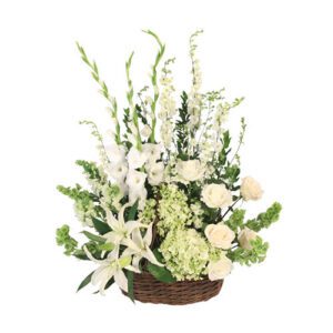 A basket of flowers with white and green plants.