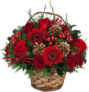 A basket of flowers with pine cones and red roses.