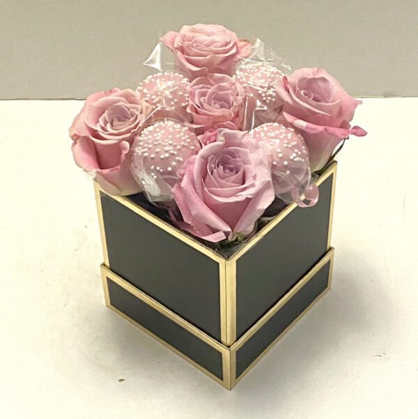 A small square box with pink roses in it.