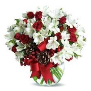A bouquet of flowers in a vase with red ribbon.