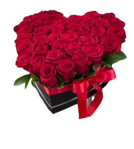 A heart shaped box of roses with red ribbon.