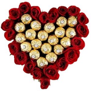 A heart shaped arrangement of chocolates and roses.