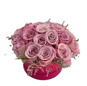 A pink flower arrangement in a red vase.