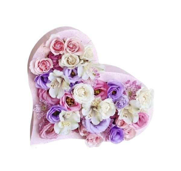 A heart shaped box filled with flowers.