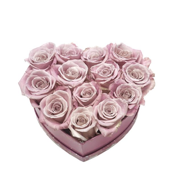 A heart shaped box filled with roses.