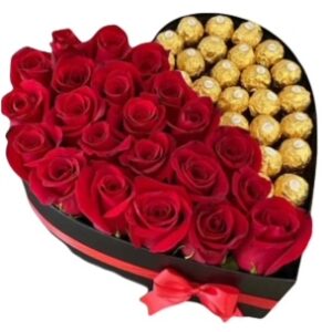 A heart shaped box filled with roses and chocolates.