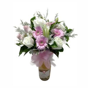 A bouquet of flowers in a vase with pink ribbon.