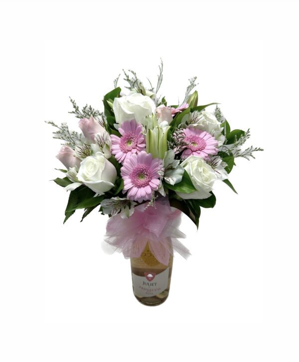 A bouquet of flowers in a vase with pink ribbon.