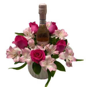 A bottle of wine in a vase with flowers.