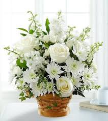 A bouquet of white flowers in a basket.