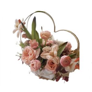 A heart shaped basket filled with flowers.