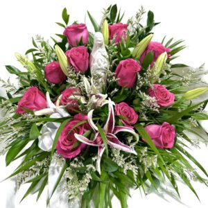 A bouquet of flowers with pink roses and greenery.
