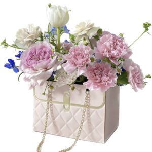 A white purse with flowers inside of it