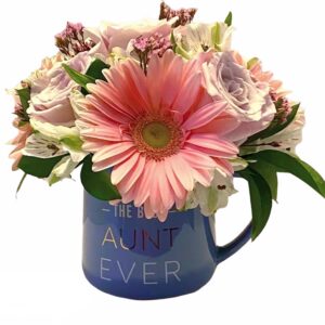A blue mug with flowers inside of it