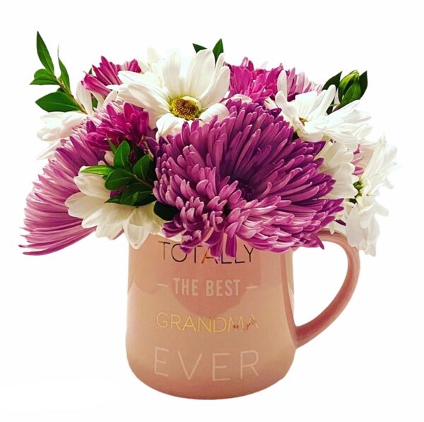 A pink mug with flowers inside of it