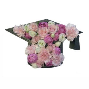 A graduation cap with flowers in it.