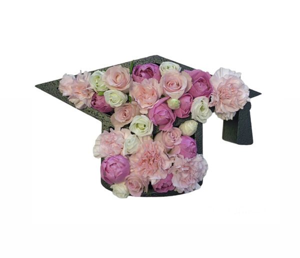 A graduation cap with flowers in it.