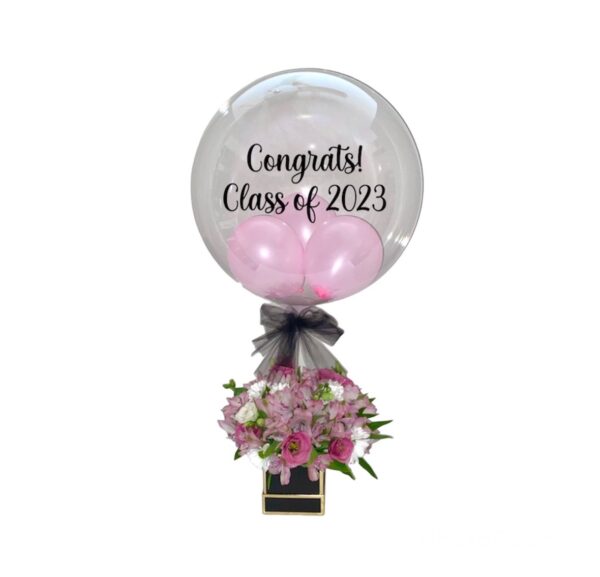 A balloon with flowers in it that says " congrats class of 2 0 2 3 ".