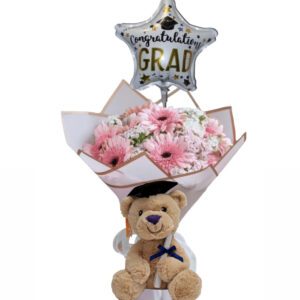 A teddy bear with flowers and balloon for graduation