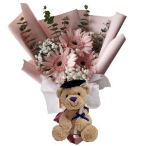 A teddy bear with flowers in it